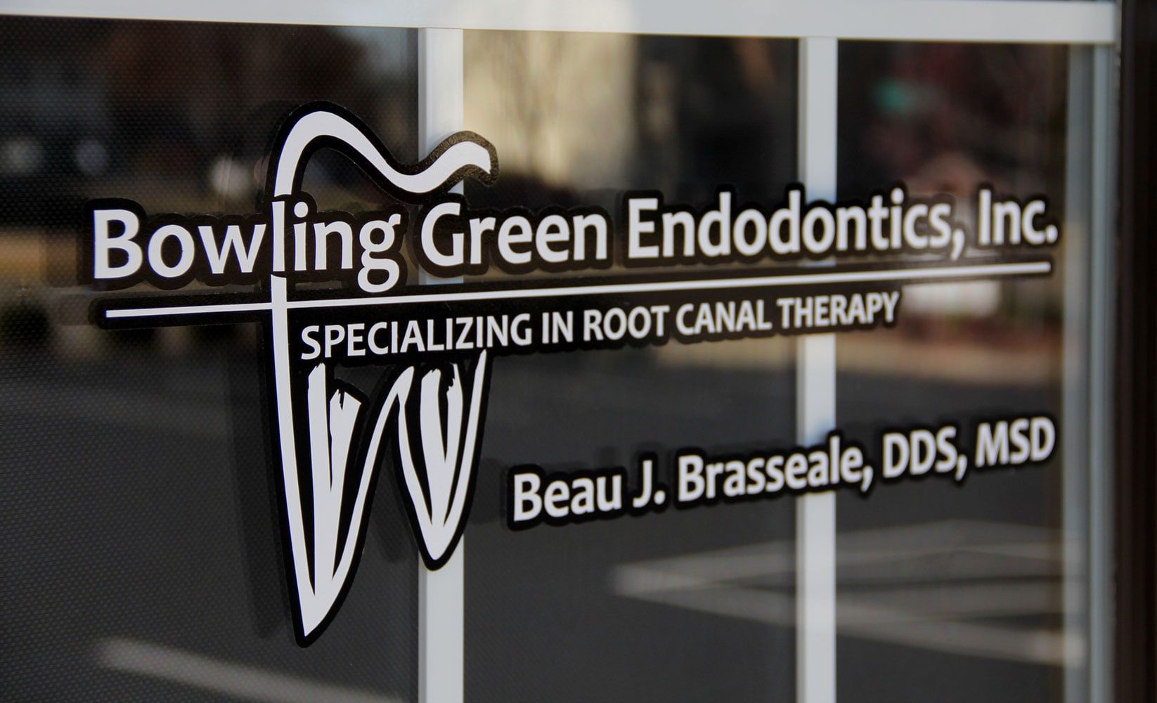 The practice's name and Dr. Brasseale's on the glass of the front door